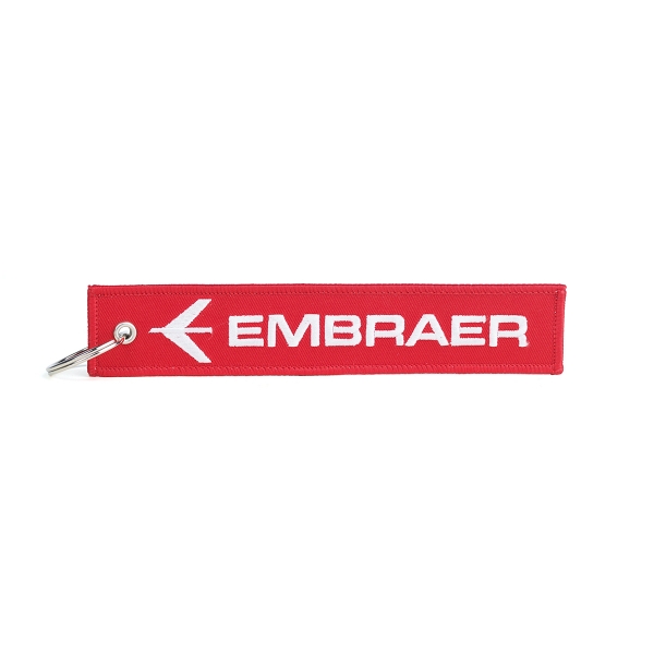 Red keytag with white embroidered Embraer logo and metal key ring on left side