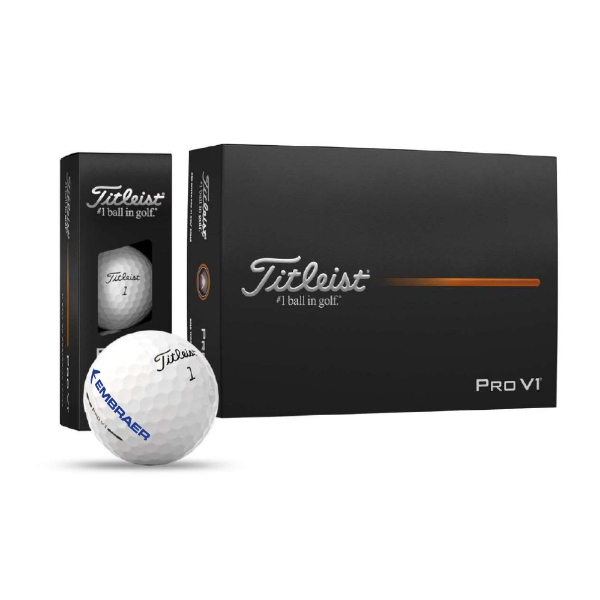 Retail packaging of Titleist Pro V1 golf balls with transparent window and Titleist 1 ball with Embraer logo in front of box